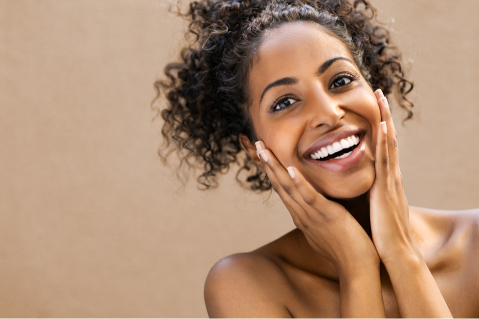 Woman smiling after face treatment
